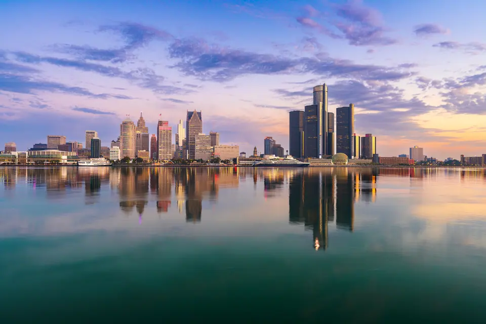 The Detroit skyline reflected in the river at dusk