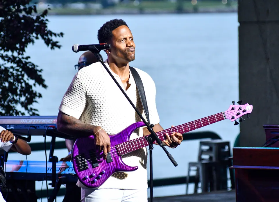 Julian Vaughn plays a purple bass guitar